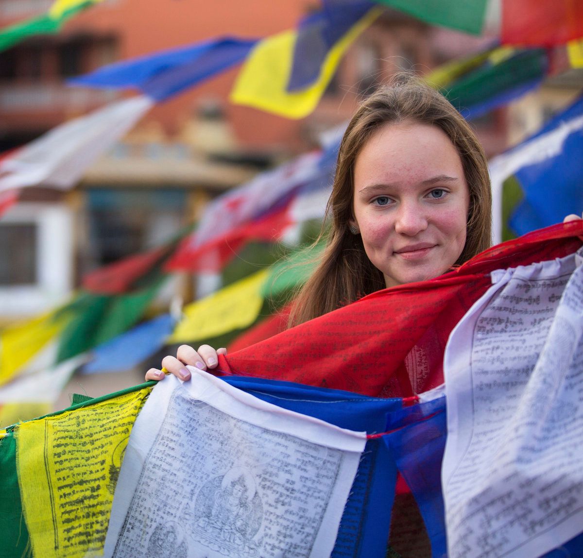 Young woman holding prayer flags